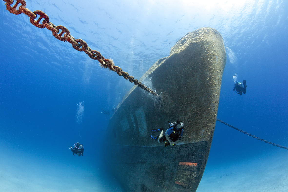 Scuba divers at Kittiwake Wreck, Cayman Islands, Caribbean © Michele Westmorland